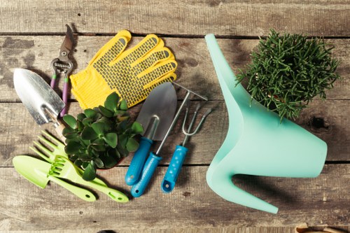 Team member trimming a hedge in Knightsbridge, close-up of hands and shears.